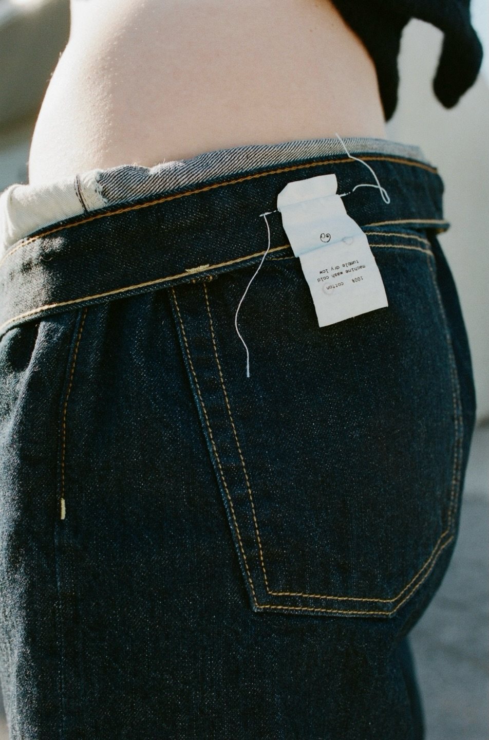 Dresen identity: woven care label on the back of raw denim jeans
